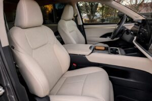 Front seats of 2027 Toyota Highlander EV inspired electric SUV with cream leather-like materials and premium stitching