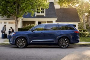 2027 Toyota Highlander EV inspired three-row electric SUV side profile on a clean suburban road